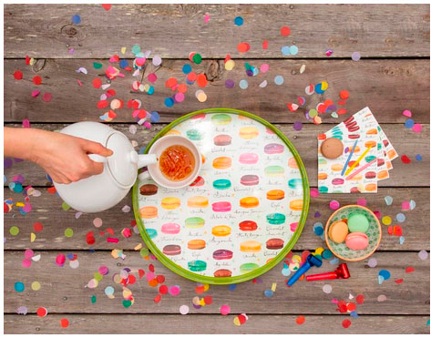 party time with some tea poured in a tea cup on a tray illustrated with macaroons